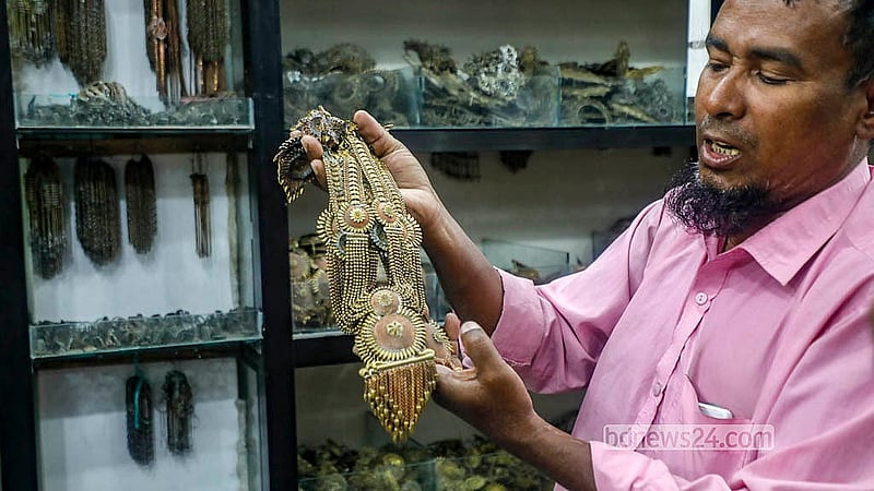 A shopkeeper displays different jewellery made in a local shop in Savar’s Bhakurta. Photo: Abdullah Al Momin