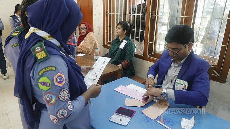 Voters collected ballot papers from the assistant presiding officer during a mock voting organised by the Election Commission at Sher-e-Bangla Nagar Government Girls' High School on Saturday, Nov 29, 2025. Photo: Abdullah al Momin