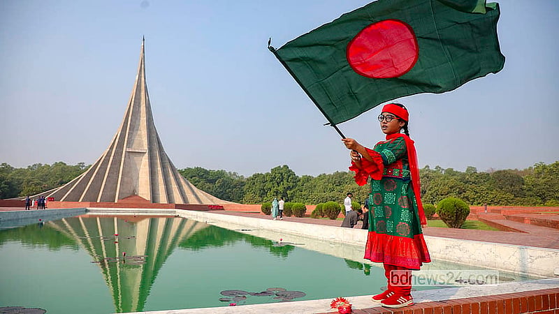 A child holds the national flag while paying tribute to the martyrs at Savar National Memorial on Thursday, Mar 26, 2026.