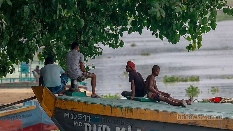 A group of four labourers rest in the shade offered by trees at the prow of a cargo vessel in Dhaka’s Gabtoli. Photo: Muhammad Mostafigur Rahman