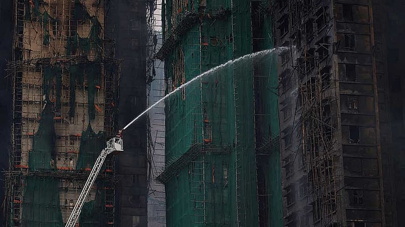 A general view shows the damaged towers at Wang Fuk Court housing complex following a deadly fire, in Tai Po, Hong Kong, China, Nov 27, 2025. REUTERS