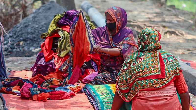 Two women fold batik fabrics after drying them in Cumilla’s Komolpur. Most of the workers in the factories here are women. Photo: Tanvir Dipu