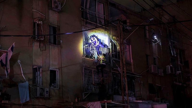 Rescue personel climb into a flat next to an impacted school site following missile attack from Iran on Israel, central Israel June 16, 2025. Photo: Reuters