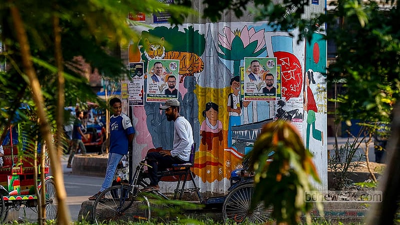 Graffiti commemorating the July Uprising once stood out on a pillar of the flyover at the Kalshi intersection in Dhaka. Now, within a year, they have been obscured b posters.. Photo: Mahmud Zaman Ovi