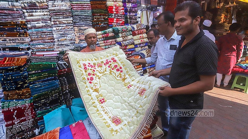 Ahead of Eid ul-Fitr, shoppers are buying prayer mats from a shop in front of the Baitul Mukarram Mosque. Photo: Abdullah al Momin