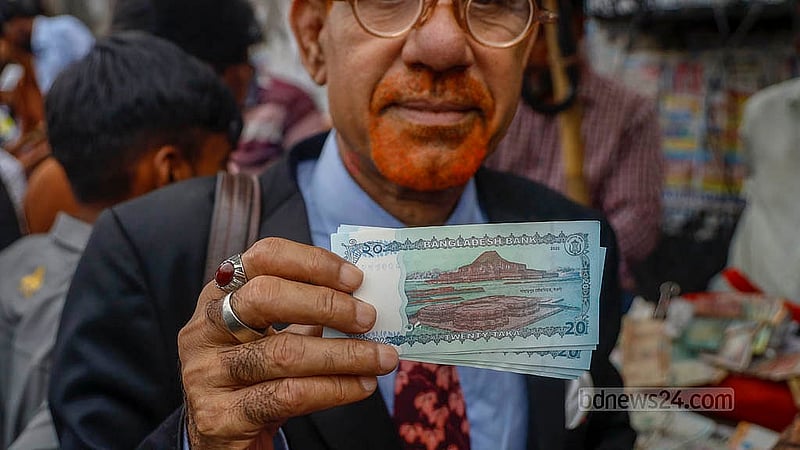 A man at a currency note exchange shop outside the Gulistan Shopping Complex buys five newly issued Tk 20 notes on Wednesday, Jun 4, 2025. Photo: Mahmud Zaman Ovi