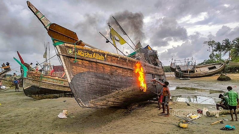 Fishermen from Teknaf and Shah Porir Dwip conduct repairs on their trawlers before taking to sea after a fishing ban is lifted. Photo: Jashim Mahmud
