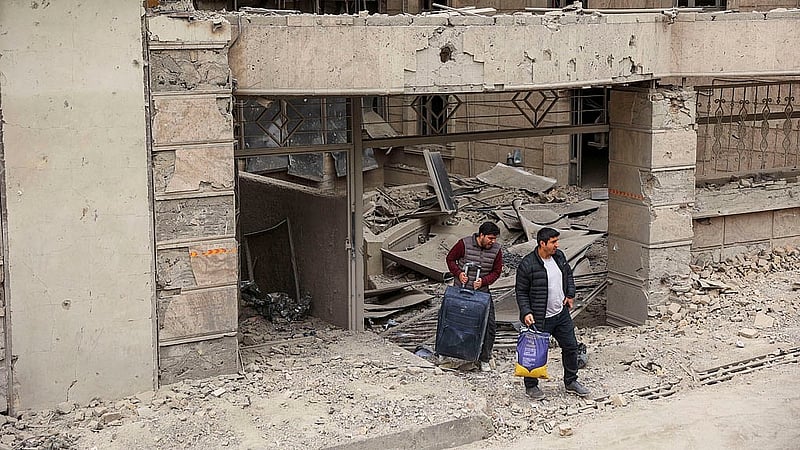 People carry their belongings following an Israeli and the U.S. strike on Gandhi Hotel Hospital, amid the U.S.-Israel conflict with Iran, in Tehran, Iran, March 2, 2026. Photo: Reuters