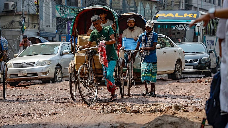 In Dhaka's Tikatuli area, rickshaw-pullers face difficulties due to the bad condition of the pothole-filled roads. Photo: Mahmud Zaman Ovi