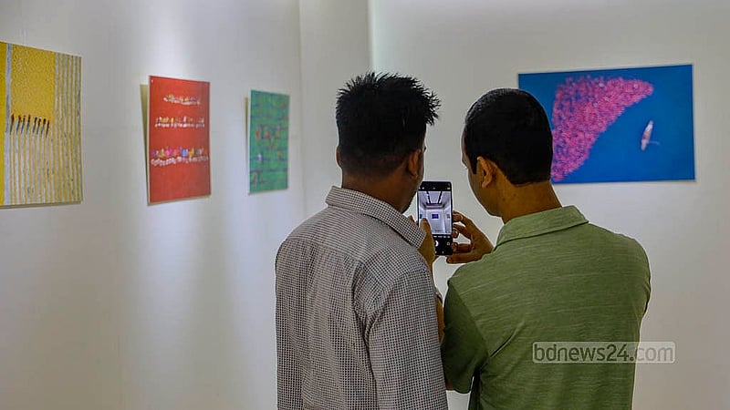 Many visitors stopped to take pictures of the displays at Touhid Parvez Biplob’s photography exhibition Bishwo Shahitto Kendro (BSK) in Dhaka. Photo: Mahmud Zaman Ovi