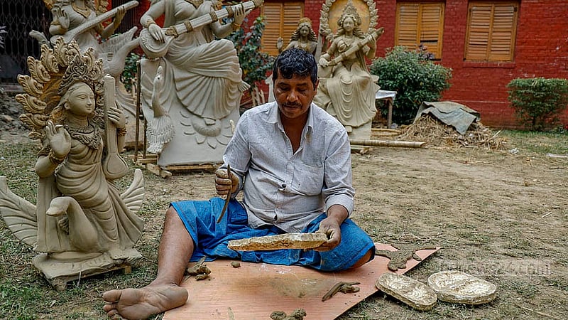 A potter fashions clay ornaments for a Saraswati idol at Jagannath Hall, Dhaka University. Photo: Mahmud Zaman Ovi