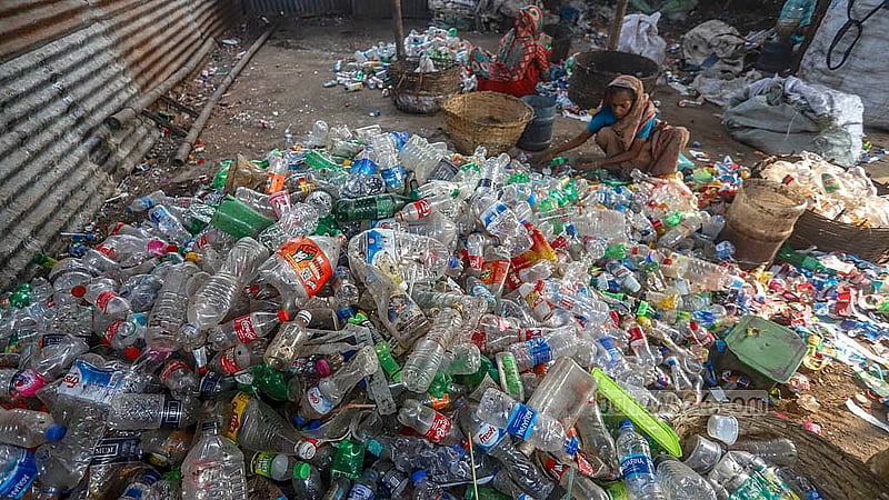 Piles of plastic waste are being sorted for recyclables by workers. Photo: Abdullah Al Momin