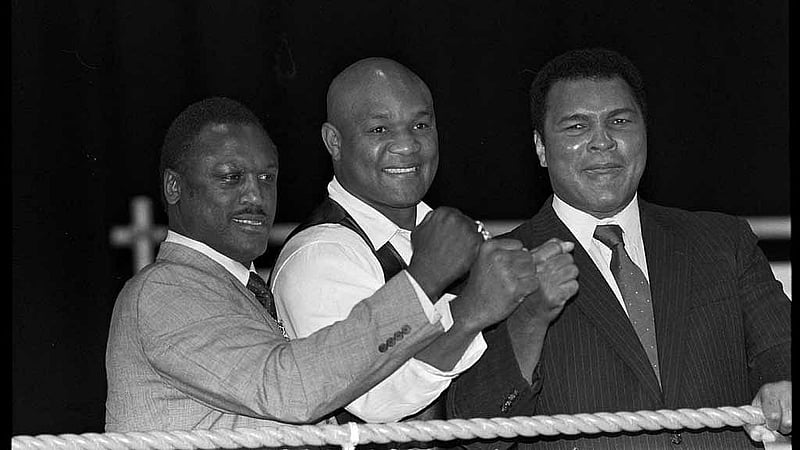 Boxers Joe Frazier, George Foreman and Muhammad Ali, raise fists at launch of film Champions Forever exploring their lives in London. October 17, 1989 REUTERS