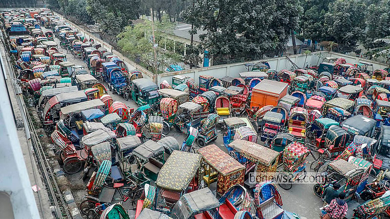 Rows of battery-powered rickshaws seized from the roads are lined up at the dumping station on the northern side of the Postogola Bridge. Photo: Abdullah Al Momin