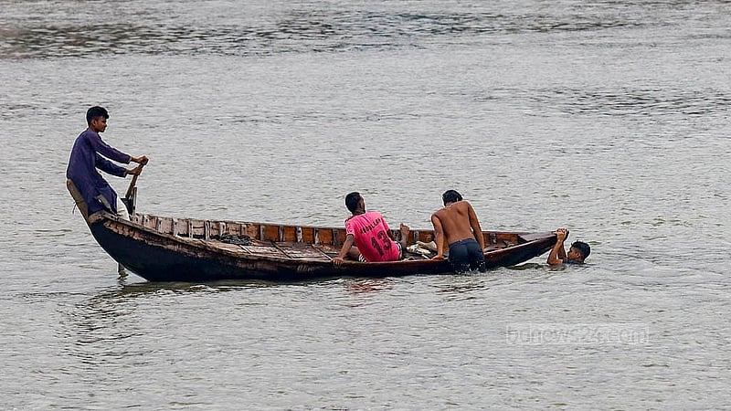 Children use a boat to take a dip in the Buriganga River. Photo: Mahmud Zaman Ovi