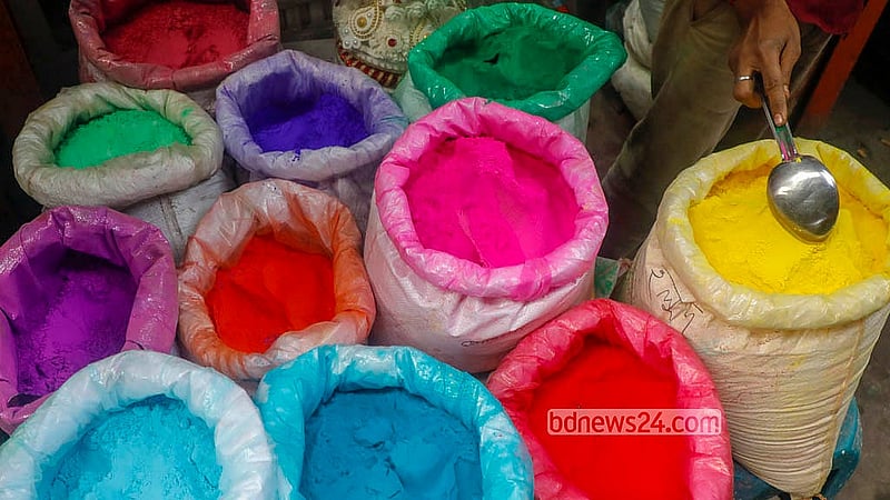 A shopkeeper displays different colours of abir (powdered colours) in the Shankhari Bazaar in Old Dhaka. Alongside kite-flying during the Shakrain festival, people celebrate by playing with colours. Photo: Abdullah Al Momin