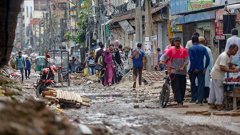 Potholes filled with water and mud block the road to Jatrabari intersection. Locals of South Jatrabari are forced to wade through it to get around. Photo: Mahmud Zaman Ovi