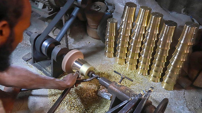A craftsman works on the design of a brass mug at the Islamia Metal Factory in Jhaulahati in Dhaka’s Kamrangirchar. Photos: Abdullah Al Momin