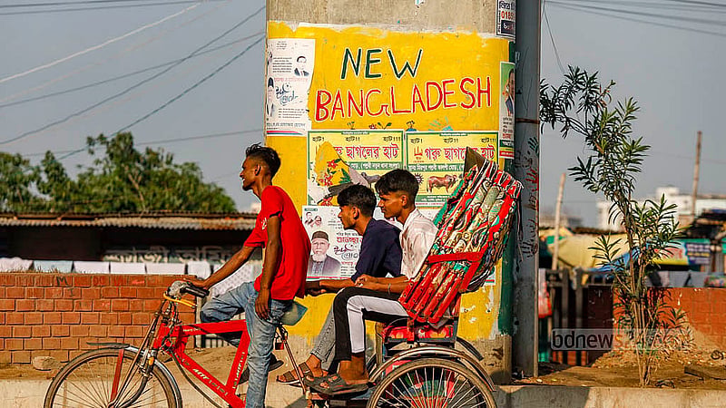“New Bangladesh” was painted on one of the pillars of the Kalshi Flyover in Dhaka’s Mirpur. Below the words was an illustration. But now, the graffiti has been covered up by posters advertising the Eid cattle market. Photo: Mahmud Zaman Ovi