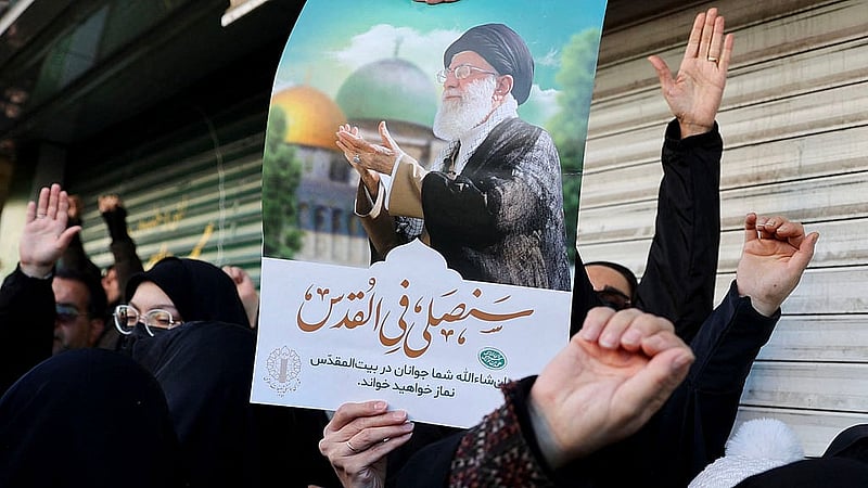 woman holds a poster with the picture of Iran's Supreme Leader Ayatollah Ali Khamenei as people gather after Khamenei was killed in Israeli and U.S. Photo: ReutersPhoto: Reutersstrikes on Saturday, in Tehran, Iran, March 1, 2026.
