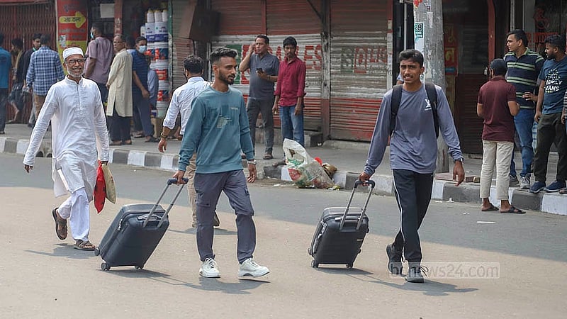 Commuters walk to their destinations on Monday, Mar 10, 2025, after traffic was halted at Chairman Bari U-turn in Banani, where garment workers blocked the road following the death of a female colleague in a road accident. Photo: Abdullah al Momin