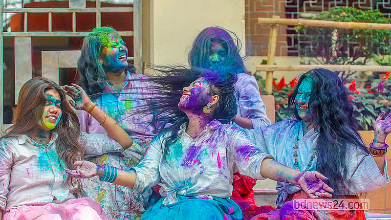 Young people, covered in powdered colours, dance during the Doljatra at Dhakeshwari Temple on Tuesday, Mar 3, 2026. Photo: Abdullah Al Momin