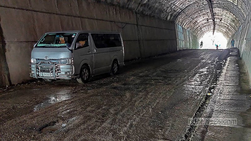 Water dripping from the walls of the Bandarban Bus Terminal Tunnel has created potholes, leaving the interior muddy. Both people and vehicles still struggle to pass through it. Photo: U She Thowai Marma