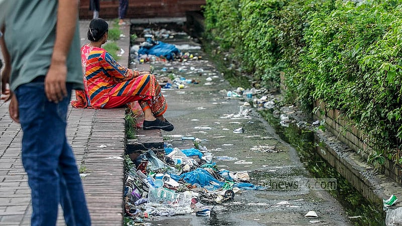 Visitors to the parliament building area struggle with the foul odour from the rotting rubbish. Photo: Abdullah Al Momin