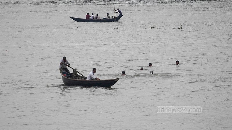 Rain has turned the Buriganga’s water from black to blue, where a group of teenagers are swimming. Photo taken in Sadarghat on Saturday, Aug 23, 2025. Photo: Abdullah Al Momin