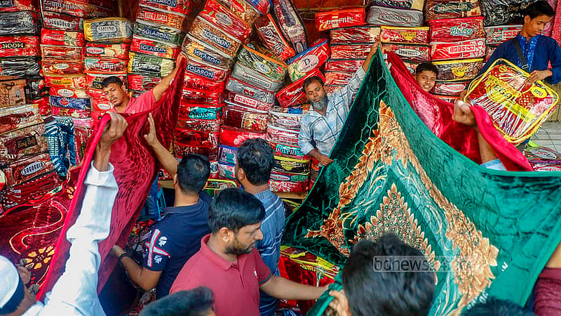 Fearing a price hike once the cold intensifies, many shoppers are crowding the stalls on GPO Road beside Baitul Mukarram Market for affordable blankets. Photo: Abdullah Al Momin