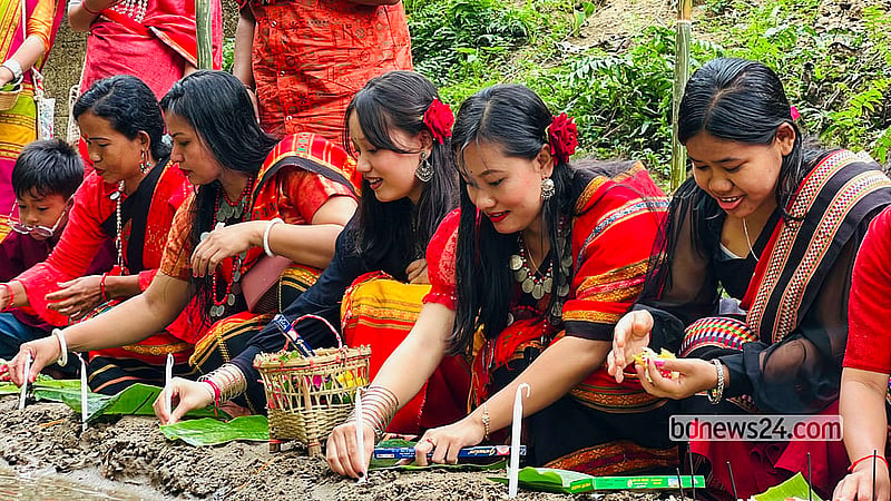 Tripura women and children pray on the banks of Khagrachhari's Chengi River on Hari Boisu. Photo: Samir Mallik