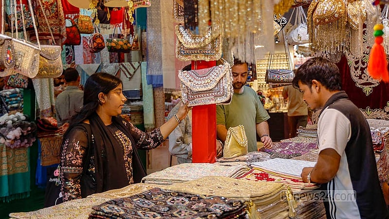 A visitor browsing Kashmiri products at a stall at the Asia International Trade Fair in Dhaka. Photo: Mahmud Zaman Ovi