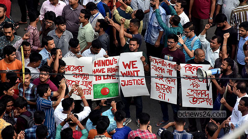Hindu devotees protest with placards at Cheragi Pahar in Chattogram on Saturday, Aug 10, 2024. Photo: Sumon Babu