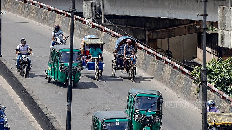 A battery-powered rickshaw moves dangerously close to speeding traffic on the Khilgaon Flyover. The lack of enforcement has allowed such vehicles to proliferate in restricted areas. Photo: Mahmud Zaman Ovi