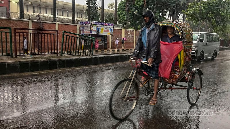 A rickshaw driver continues to ply their trade on Dhaka’s streets on Monday, May 27, 2024, despite the rain brought on by Cyclone Remal. Photo: Mostafigur Rahman