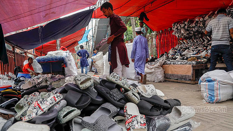 Hawkers have set up shoe stalls on the footpath near the Fire Station at Dhaka’s Mirpur-10. Only a narrow, difficult path remains for the use of pedestrians. Photo: Mahmud Zaman Ovi