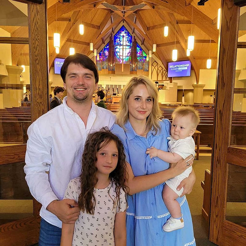 Taras Atamanchuk with his daughter Violet and wife Viktoria attend his son Maximilian's baptism at a church in Sugar Land, Texas, US, Apr 14, 2024. Courtesy of Taras Atamanchuk/Handout via REUTERS