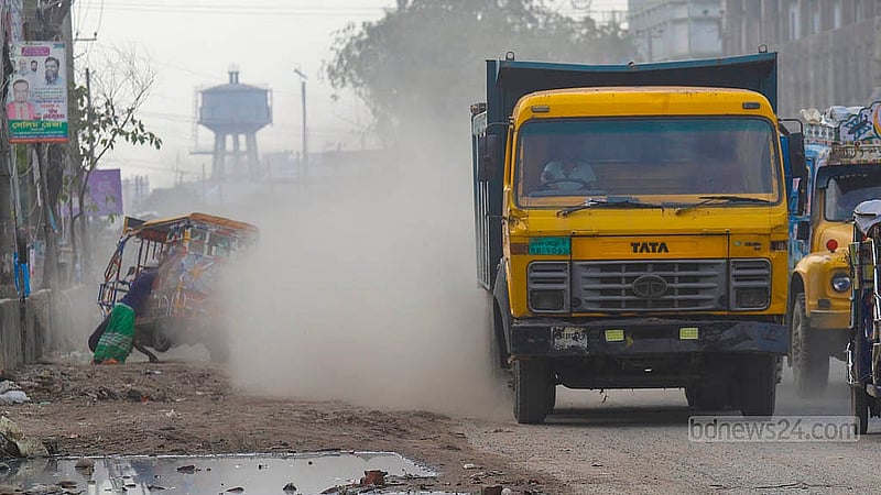 A truck is plying on the Dhaka-Narayanganj highway, leaving clouds of dust behind.