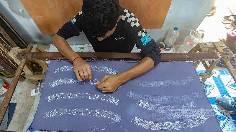 An artisan is fully immersed in embroidery work ahead of Eid-ul-Fitr, a moment captured at Benarasi Palli in Dhaka’s Mirpur. Photo: Abdullah al Momin