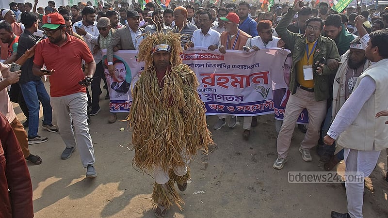 A BNP activist is wrapped in a sheaf of paddy party symbol during a campaign rally at Chattogram’s Polo Ground on Sunday, Jan 25, 2026. Photo: Suman Babu