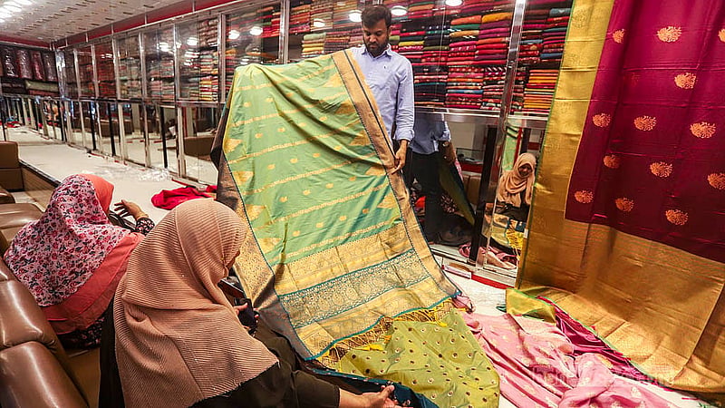 Customers crowd a store at Benarasi Palli in Dhaka’s Mirpur. The buyers browse the selections and haggle before making their purchases for Eid. Photo: Abdullah al Momin