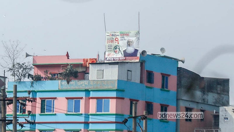 A colourful billboard of a candidate has been put up on the roof of a multi-storey building in Old Dhaka’s Islambagh. Although the use of colourful billboards in campaigning for the national election is prohibited, many candidates are not complying. Photo: Abdullah Al Momin