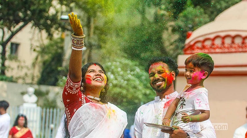 A child arrives with his parents to play with powdered colours at Dhakeshwari Temple on Tuesday, Mar 3, 2026. Photo: Abdullah Al Momin