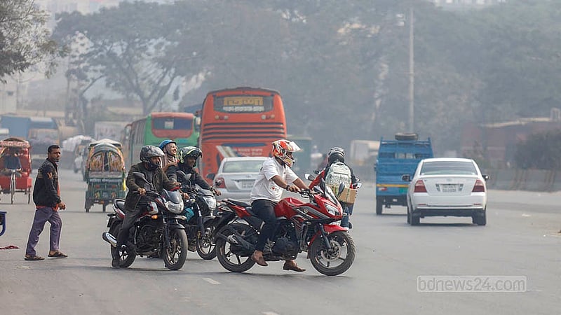 Motorcyclists wait along the roadside at Matuail to take a U-turn, standing exposed as speeding vehicles pass on the Dhaka–Chattogram highway. Photo: Mahmud Zaman Ovi