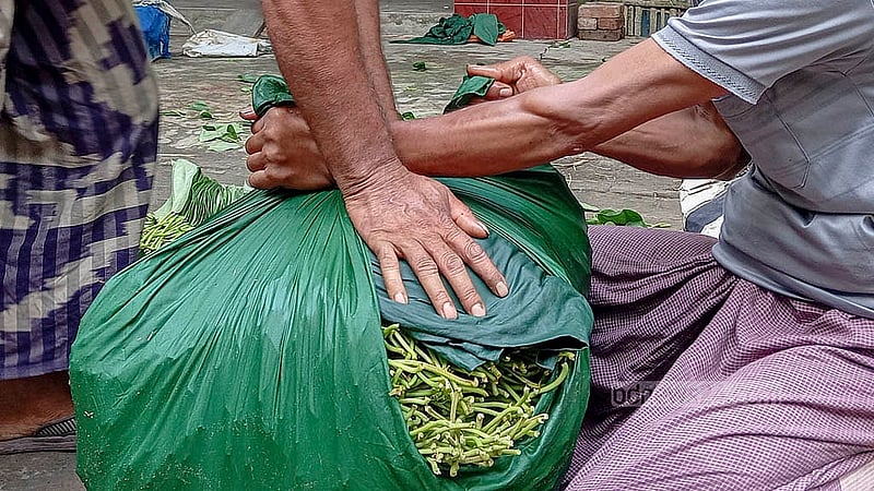 Wholesalers at Jadupar pack betel leaves for delivery to markets across the country. Photo: Abul Hayat Shahin