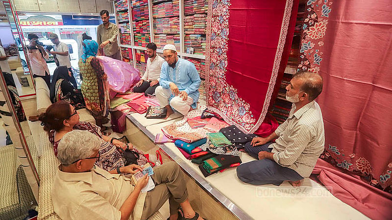 Customers buy sarees for friends and family ahead of Eid-ul-Fitr at Benarasi Palli in Dhaka’s Mirpur. Photo: Abdullah al Momin