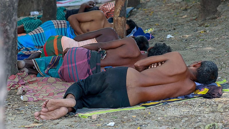 Labourers take naps in the shade to escape the heat of the summer afternoon in Dhaka’s Gabtoli. Photo: Muhammad Mostafigur Rahman
