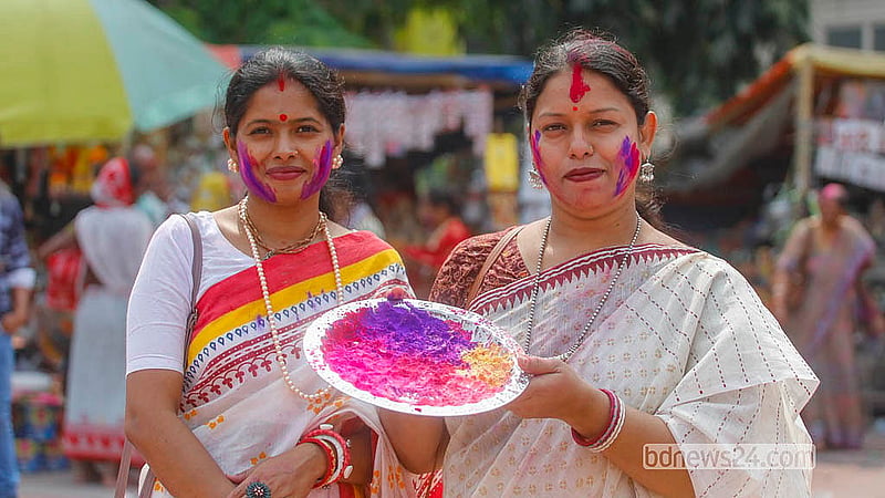 A woman carries vibrant powdered colours during the Dol festival at Dhakeshwari Temple on Tuesday, Mar 3, 2026. Photo: Abdullah Al Momin