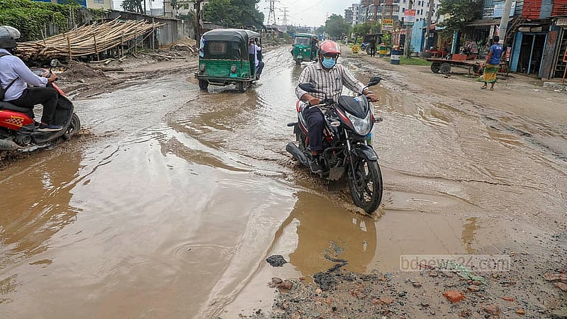 Rainwater pools in the potholes along the road from Hasnabad to Pangaon Container Terminal, creating hazards for drivers of all vehicles. Photo: Abdullah Al Momin