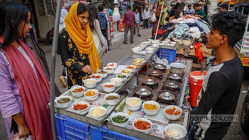Though the winter chill has yet to descend on Dhaka, street vendors are already packing the pavement with stalls selling rice cakes. Some of these stalls have even become permanent fixtures. Photo: Mahmud Zaman Ovi